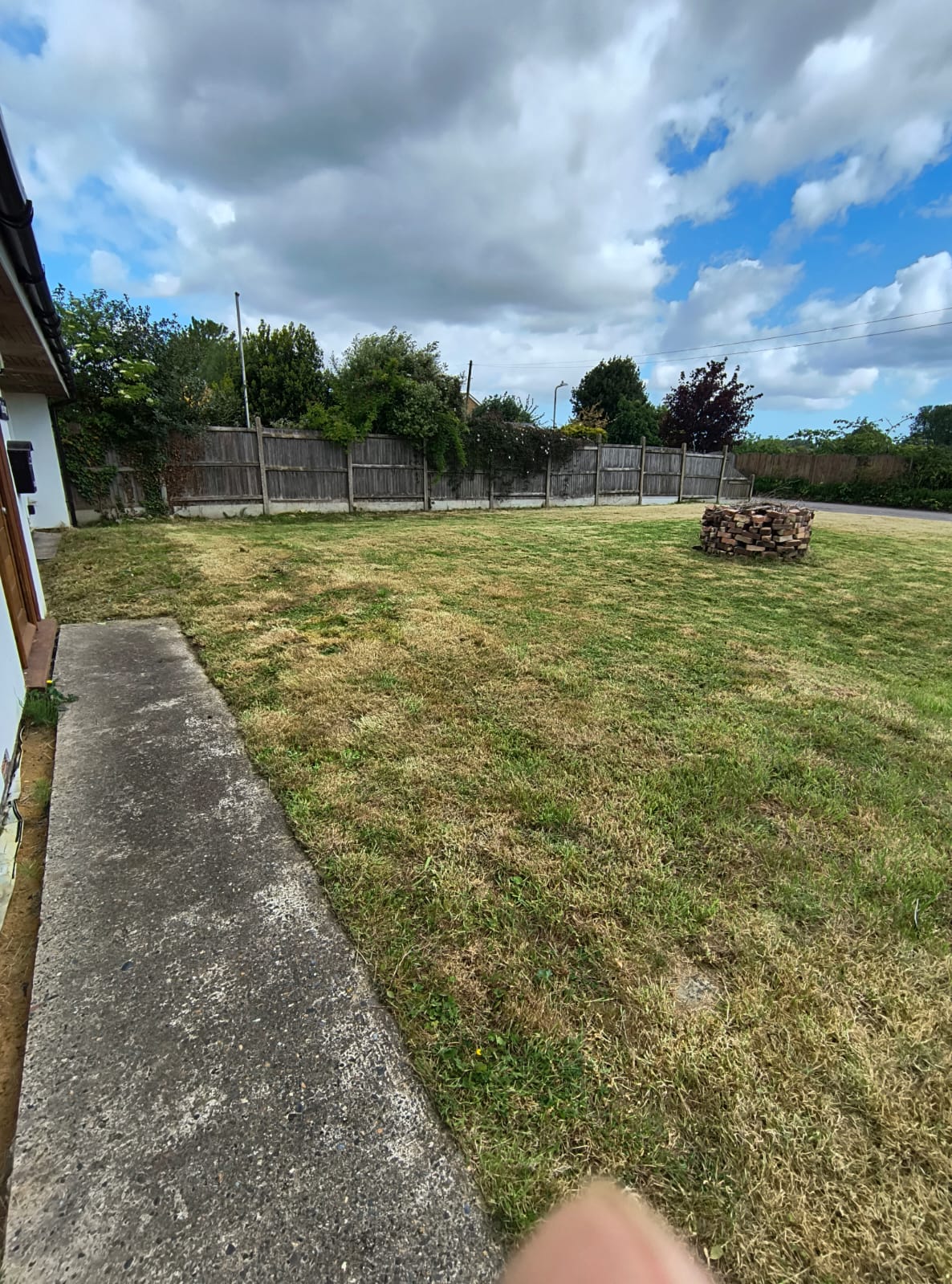 A freshly mown front garden lawn in Sandwich, Kent, after a full mow, strim and grass removal